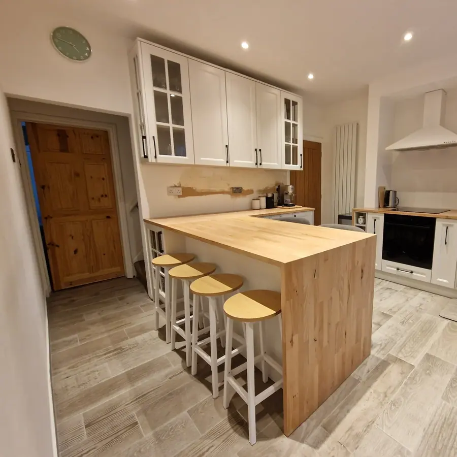 White shaker kitchen with an oak island