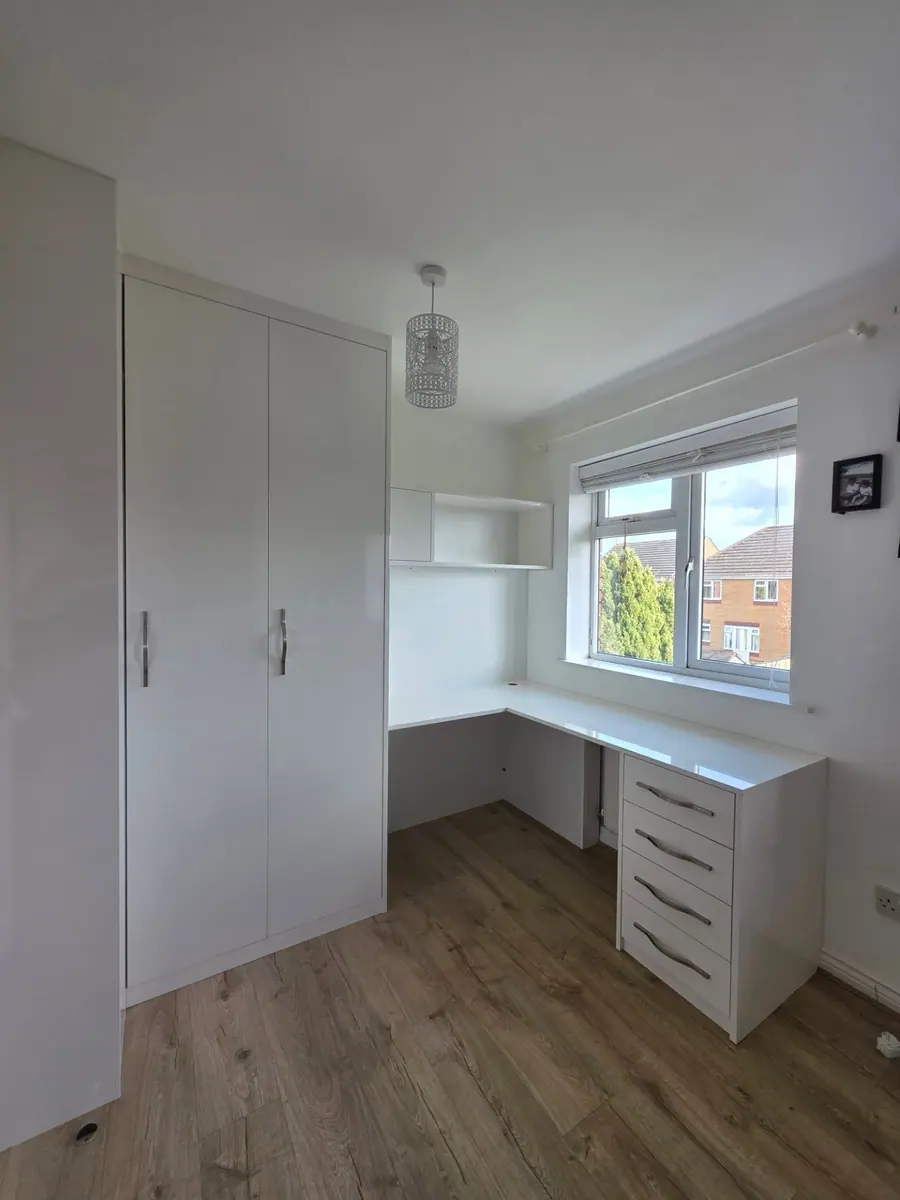 White corner wardrobe with a built-in desk