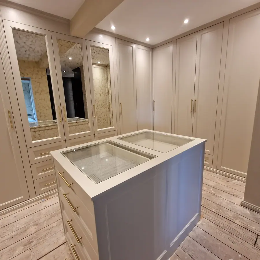 Walk-in wardrobe with shaker fronts and brass handles