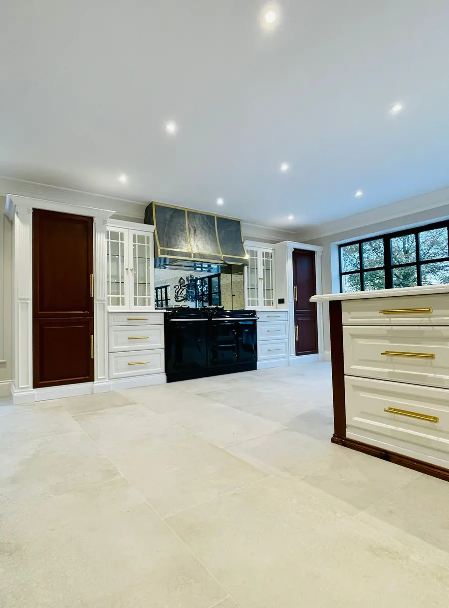 Painted shaker kitchen with brass bar handles and an island
